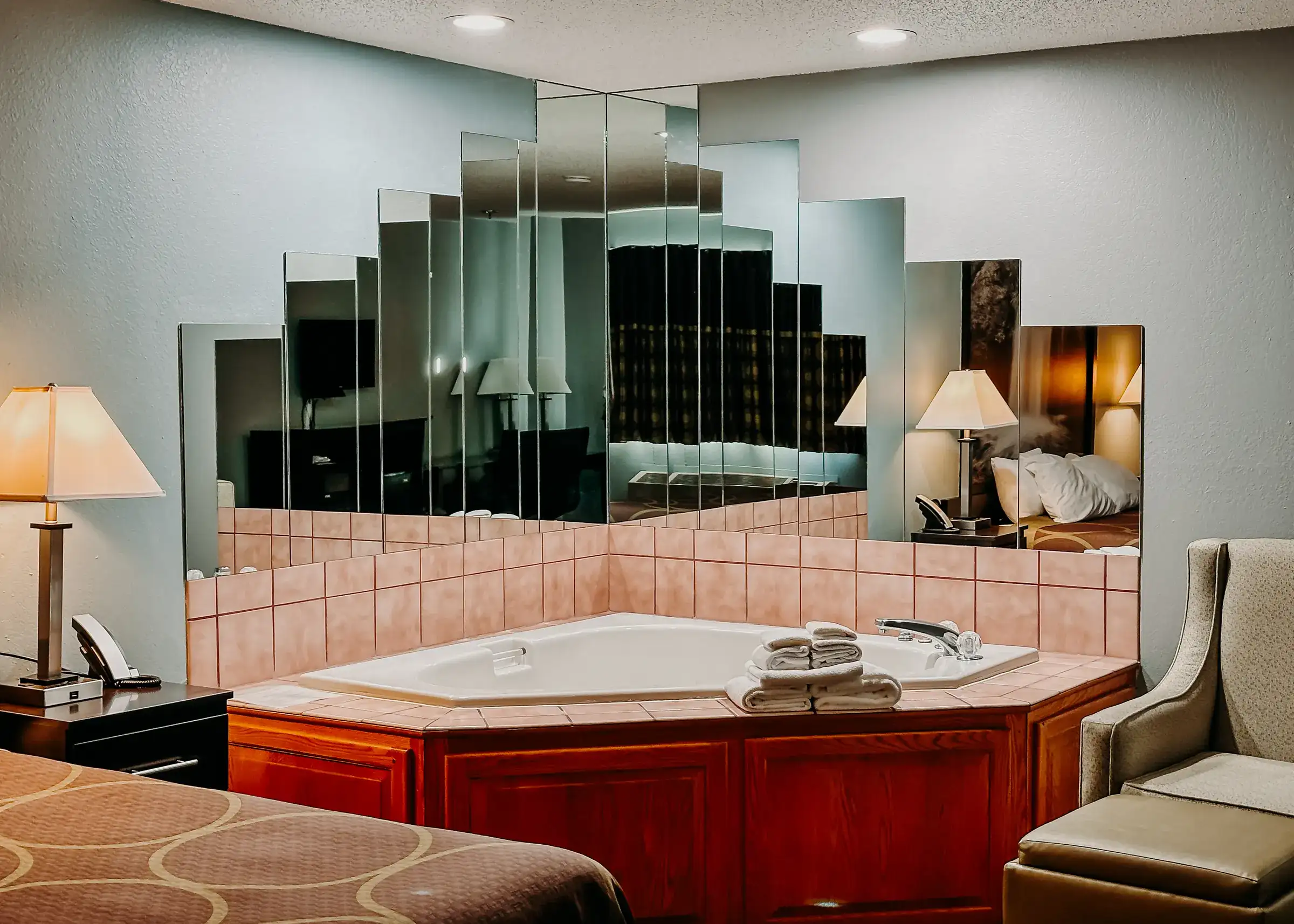 The private jetted tub in an executive room, set into a tiled surround