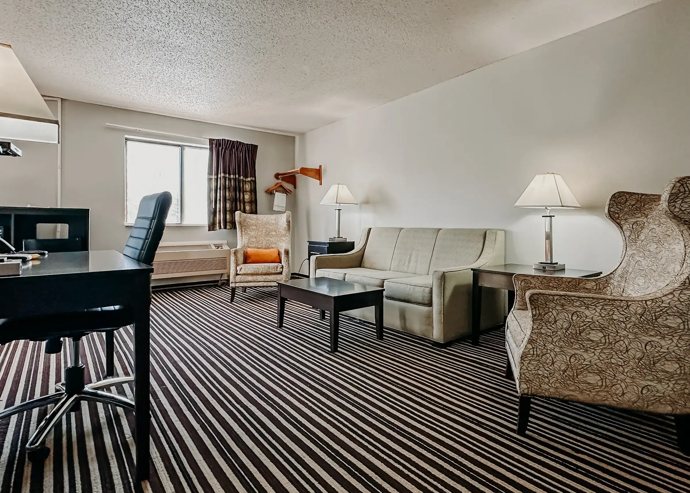 Executive room sitting area with a double sofa bed and armchairs