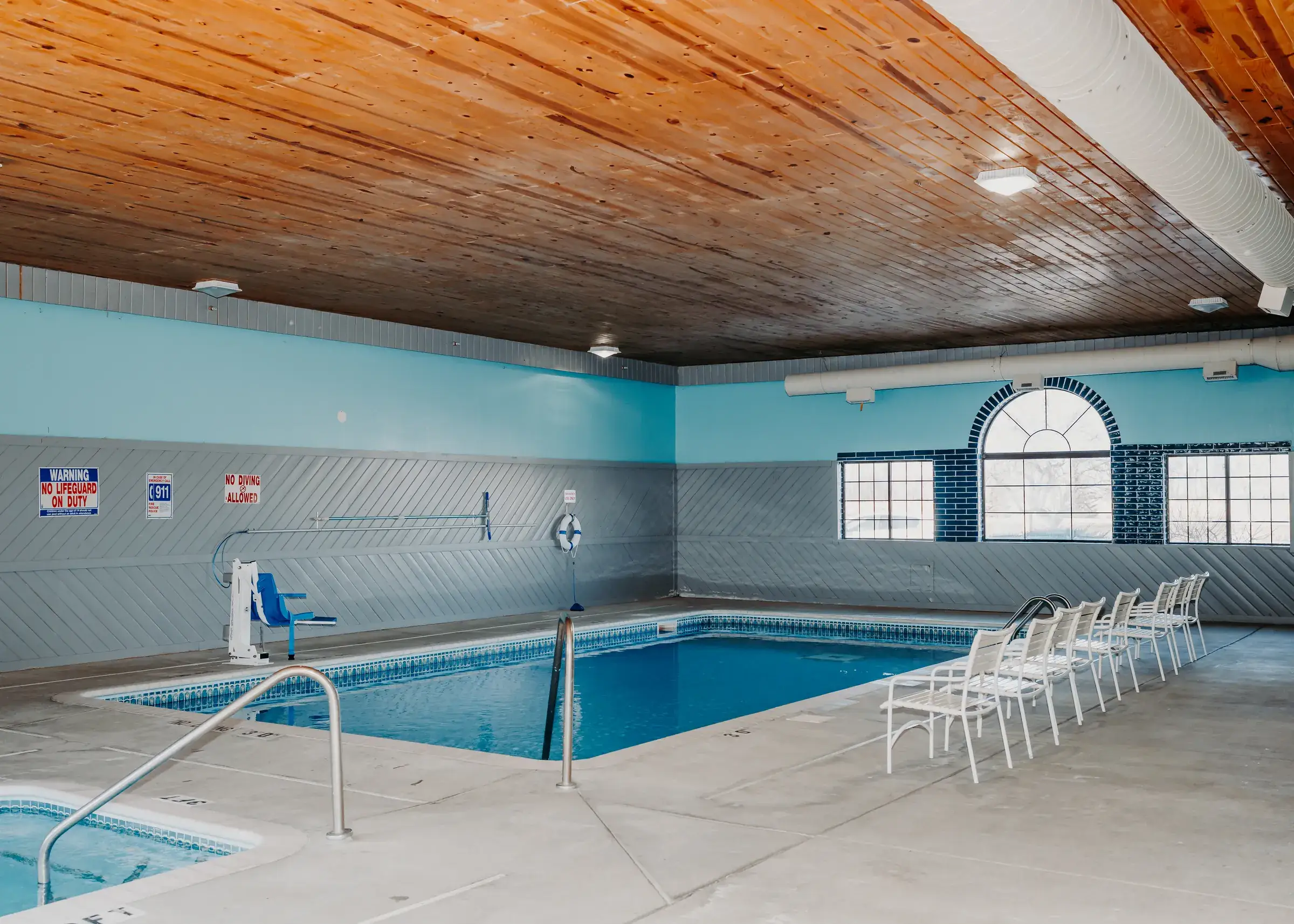The heated indoor pool, lit by an arched window wall